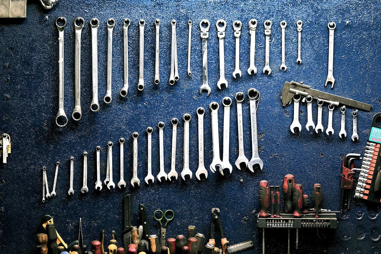 Spanners hung in size order on a workshop wall